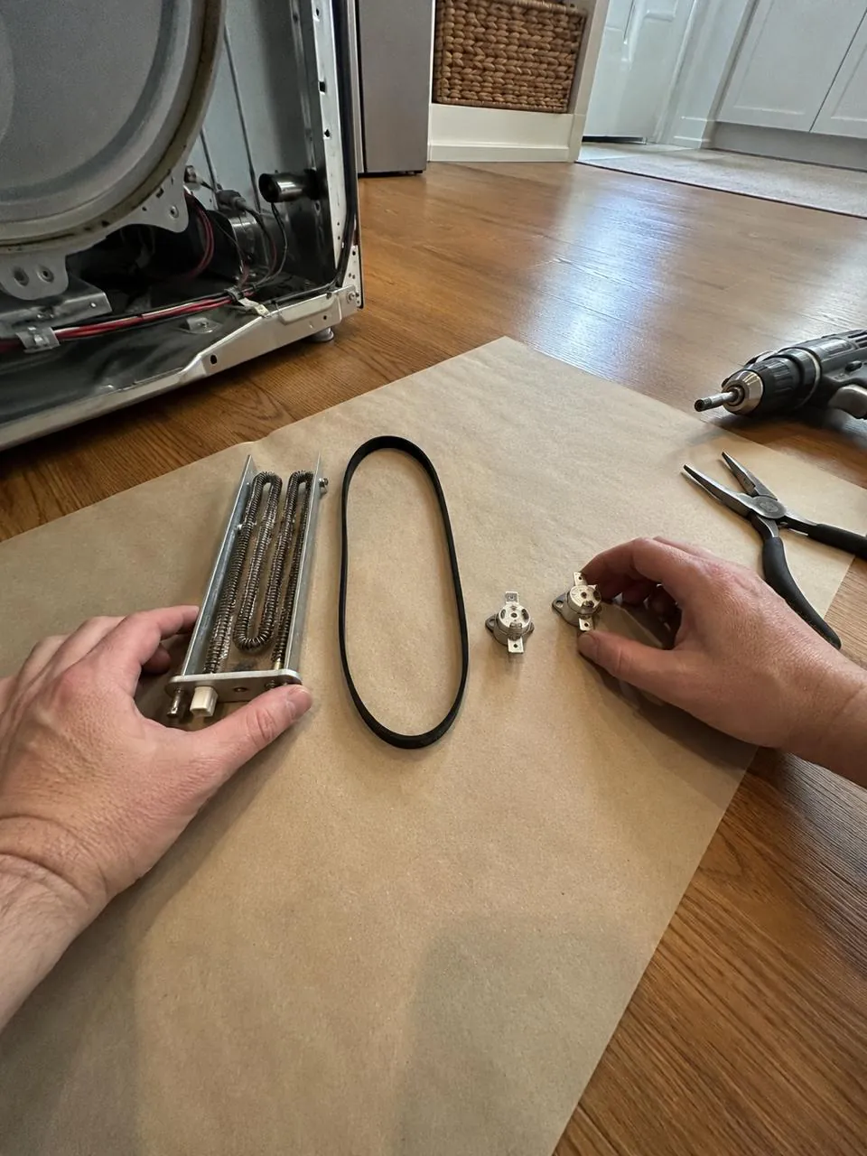 Technician repairing dryer heating element and belt in San Diego home